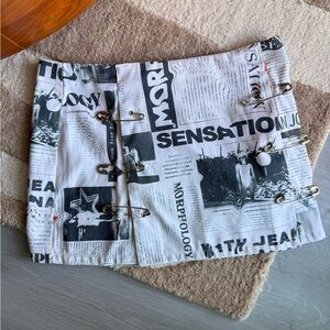 With Jean Newspaper Print Safety Pin Mini Skirt